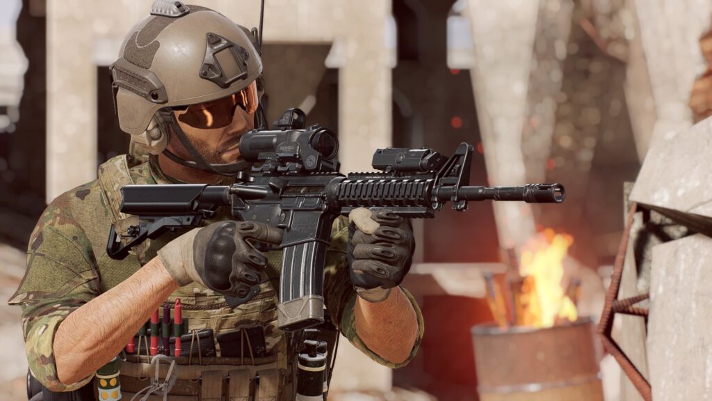 A military soldier aims his assault rifle at something off camera. Level design plays an important part in player immersion.